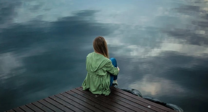 depression girl sitting by the river